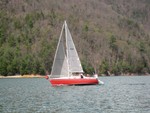 Sam on the rail of Windward, Jeff Arnfield at helm