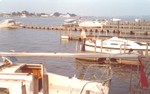 Rigging the boats at Norfolk, Bob and Jane Waterfield with Camelot..