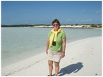 Adair is walking on the beach on Double Breasted Cay.