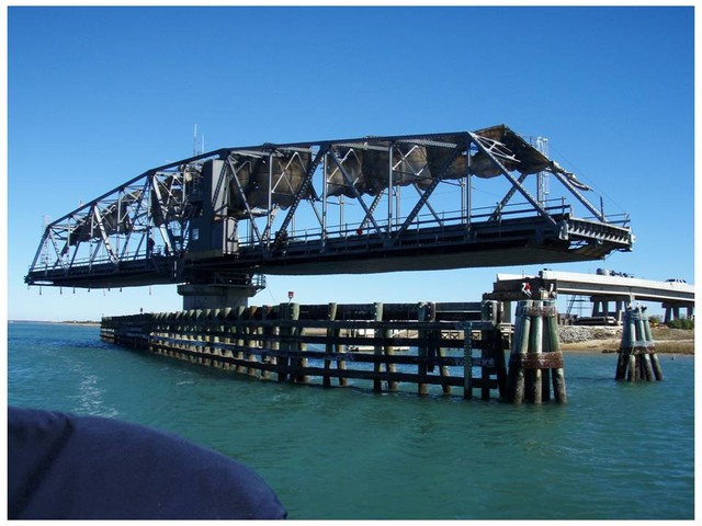 We arrived at the Surf City bridge aroud 11 am and asked for an opening.  The bridge tender agreed, but told us that the next bridge was being painted and only opened at noon. Since we could not get there in time, we stopped in Surf City, walked around, at a restaurant meal, and went through the Figure Eight Island bridge the next day.