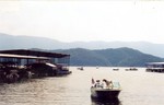 Cruiser on bow of Clarke Lucas' motorboat "No Wind" at S. Holston