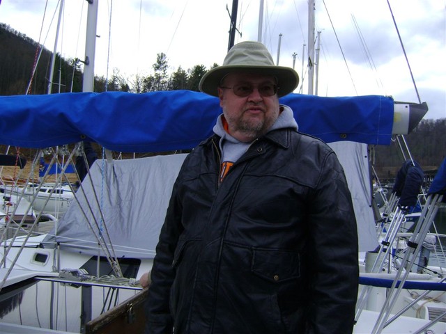 Spiffy looking captain looking over the boat in preparation for Frostbite Race