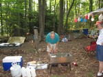 Bill Murdoch putting on final touches to meal with Billie Middaugh's assistance..