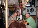 Paul del Rio and Bill Murdoch, serious discussion of bar tab..