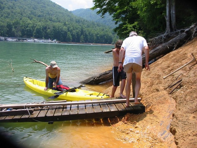 Low water and mud make dock construction especially difficult this year! (picture from C. Lucas)