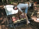 setting the chickens and pig over the fire, very high tech piece of old fence from Bill's back yard..
